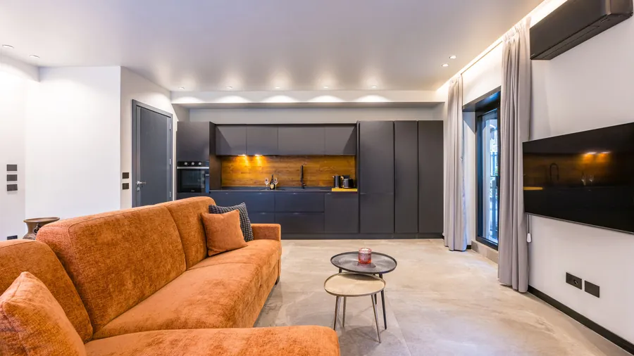 Zona living Santopaolo 3 con cucina antracite a vista, divano letto e accesso al patio